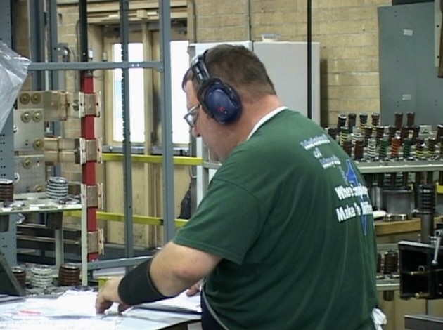 A worker wearing the proper hearing protection specified in the hearing loss prevention program