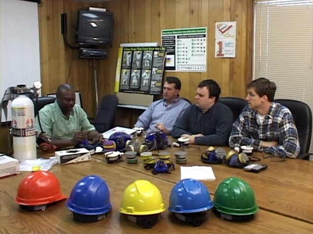 A manager training workers on the respiratory protection program and OSHA regulations standard