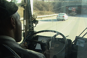 A bus operator driving safely and avoiding distractions to keep his attention on driving