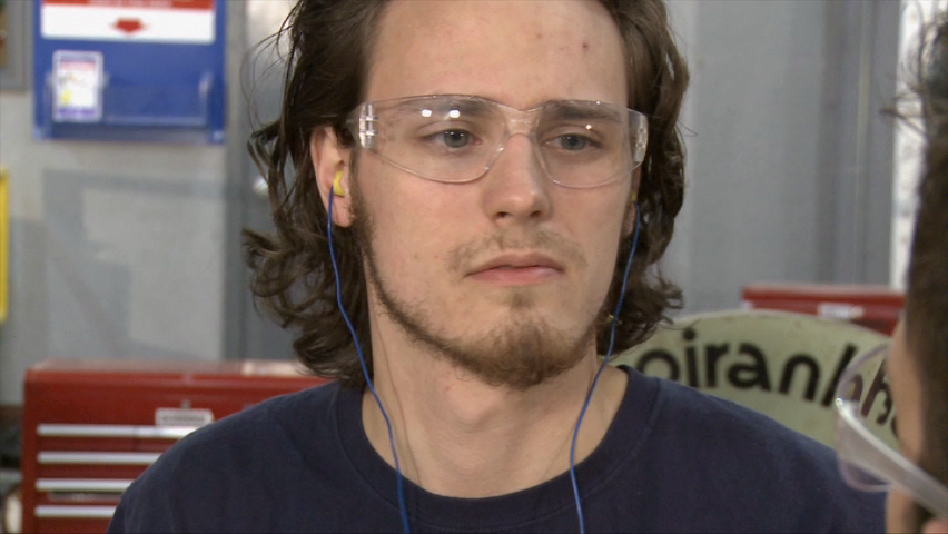 A worker following his company's hearing conservation program and wearing proper hearing protection