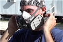 An industrial worker following the OSHA Respiratory Protection Standard and safety training