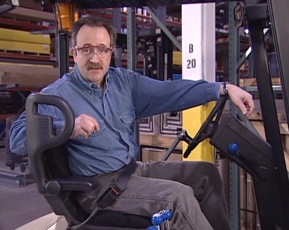 A safety trainer discussing forklift operator safety and avoiding injury while operating a forklift