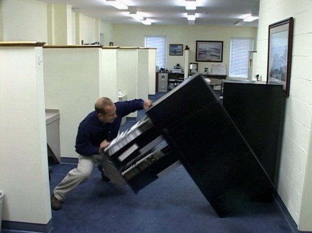 An office worker injured by a filing cabinet tipping over because safe work practices were ignored