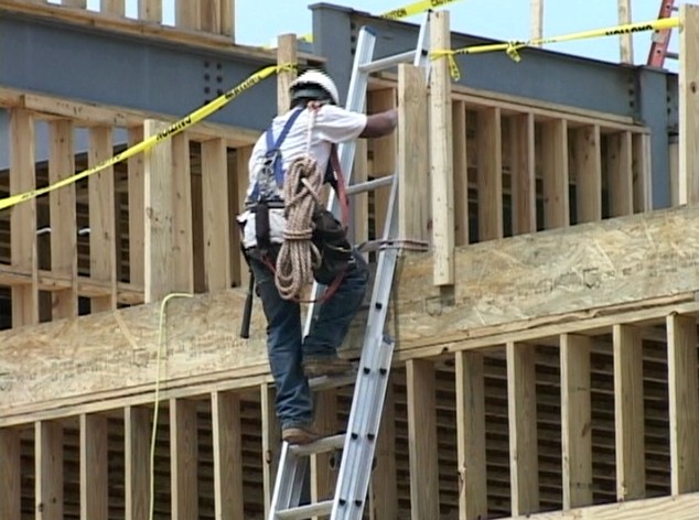 A construction worker preparing for safety training orientation presented by Safety Bob Synnett