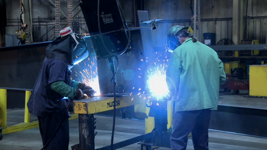 Welders working while being aware of the potential hazards of their job to stay safe at work