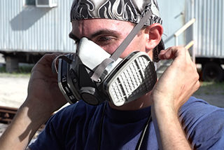 An industrial worker following the OSHA Respiratory Protection Standard and safety training