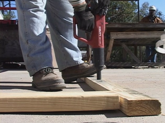 A worker protecting his feet from workplace hazards with proper safety footwear to avoid injury