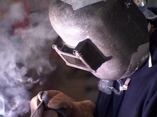 A worker taking precautions to avoid exposure to hexavalent chromium and avoid injury or death