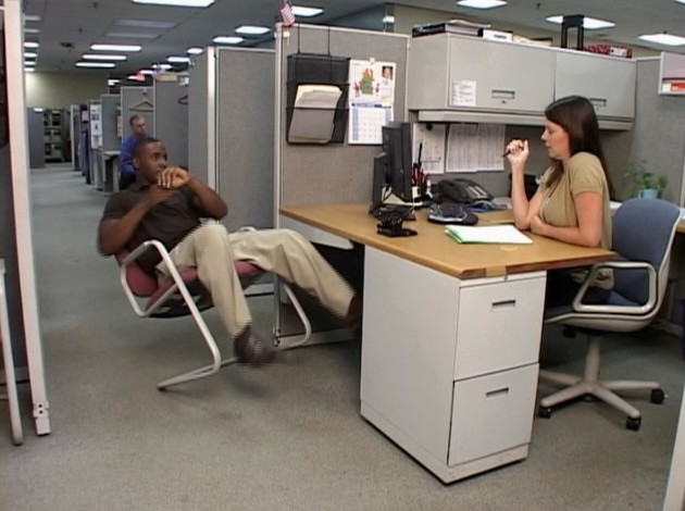 An office worker with bad judgment and lacking a positive safety attitude leaning back in a chair 