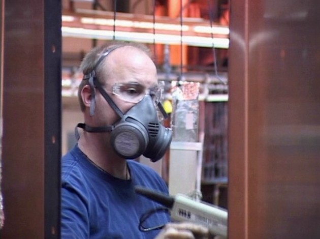 An industrial worker following the OSHA Respiratory Protection Standard and safety training