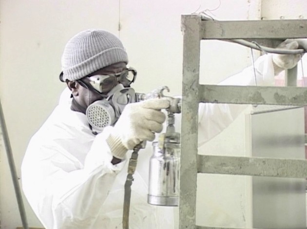 A worker wearing the proper respiratory protection to avoid potential workplace hazards and injury