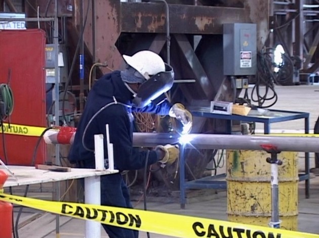 A welder demonstrating OSHA safety procedures to prevent accidents and injury while welding