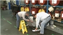 Industrial workers demonstrating good housekeeping practices after a chemical spill in the workplace