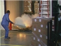 A worker that received proper training using a fire extinguisher to put out a fire in the workplace 