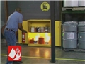 A worker making the correct fire extinguisher decisions and putting out a fire in the workplace