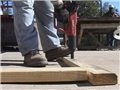 A worker protecting his feet from workplace hazards with proper safety footwear to avoid injury