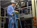 A worker using proper safety precautions and following safe work practices while using a ladder