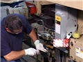 A worker controlling hazardous energy by following his lockout / tagout or LOTO safety training