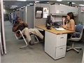 An office worker with bad judgment and lacking a positive safety attitude leaning back in a chair 