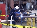 A welder demonstrating OSHA safety procedures to prevent accidents and injury while welding